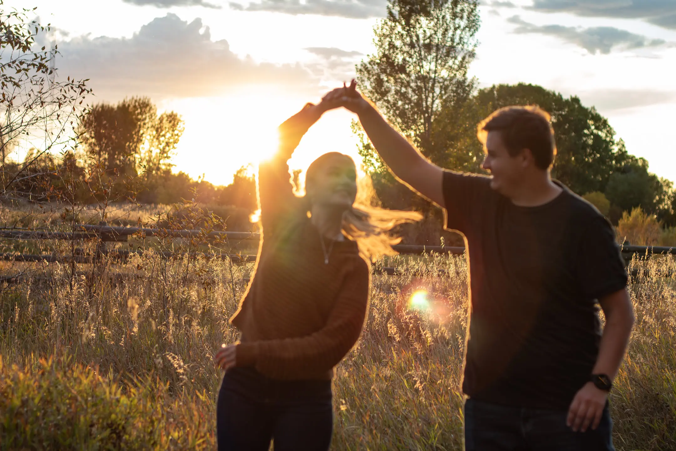the couple engagement dancing in the sunset